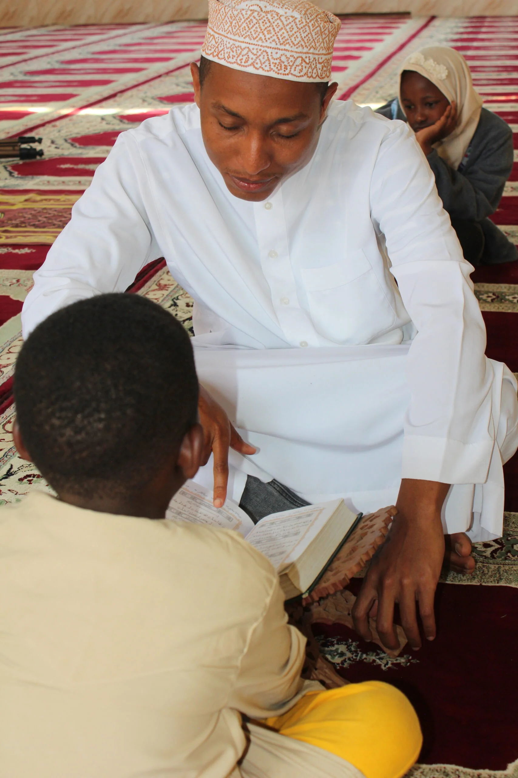 Tajweed Guidance with Ustadz and Student on Wooden Rehal