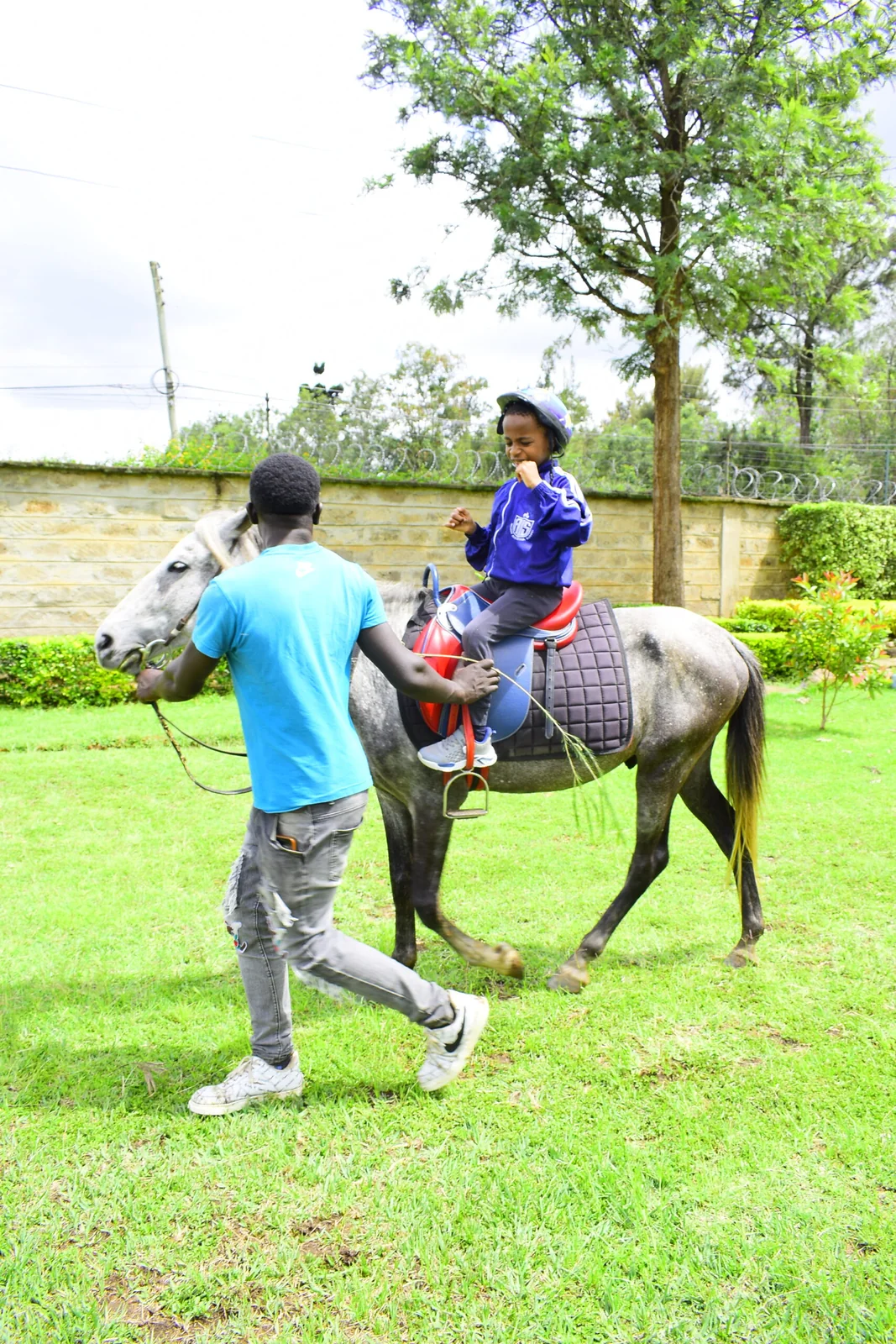 Equestrian Pony Riding Session with Safety Helmet and Handler